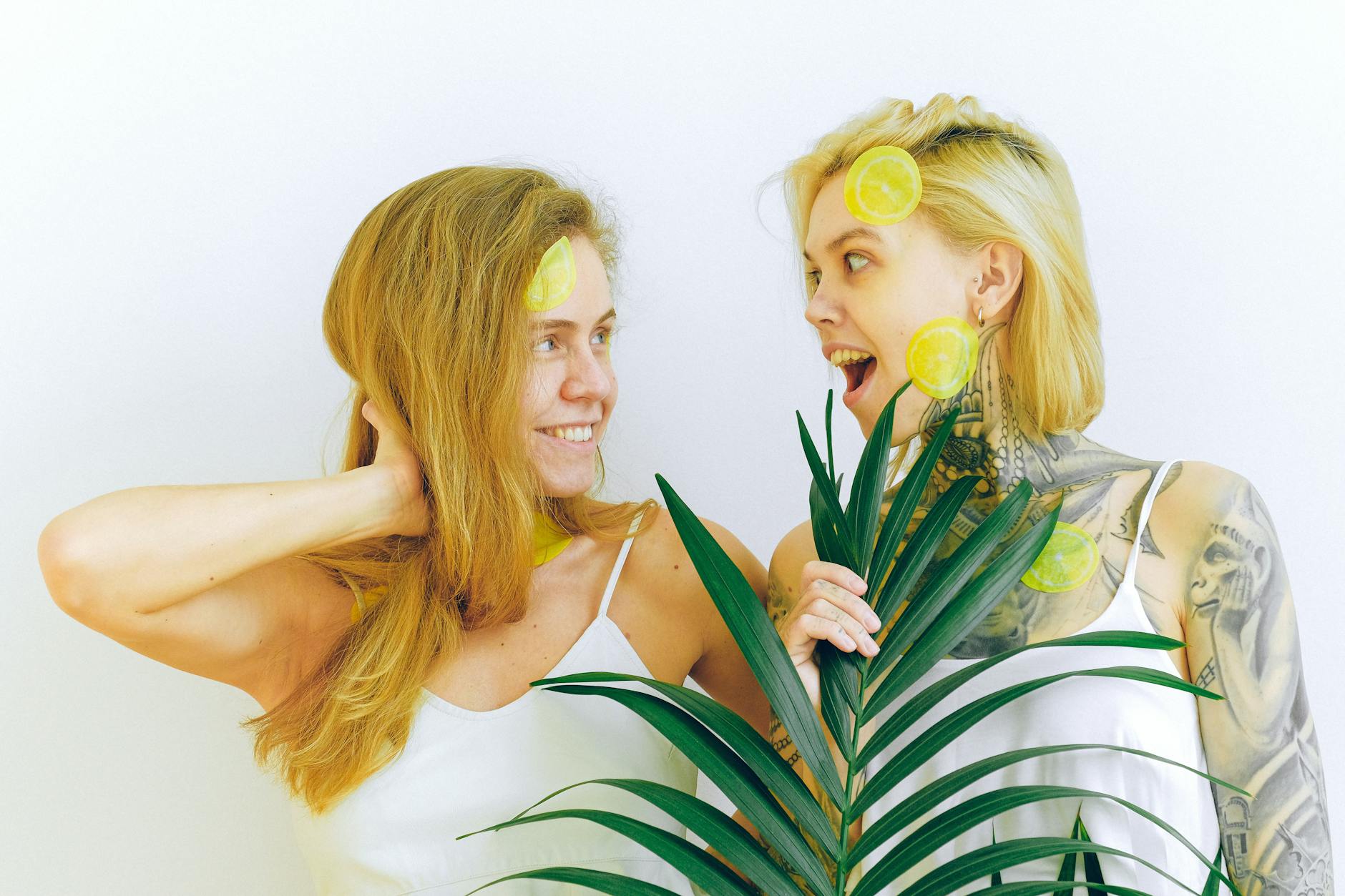 Two women smiling together with lemons, expressing joy and connection