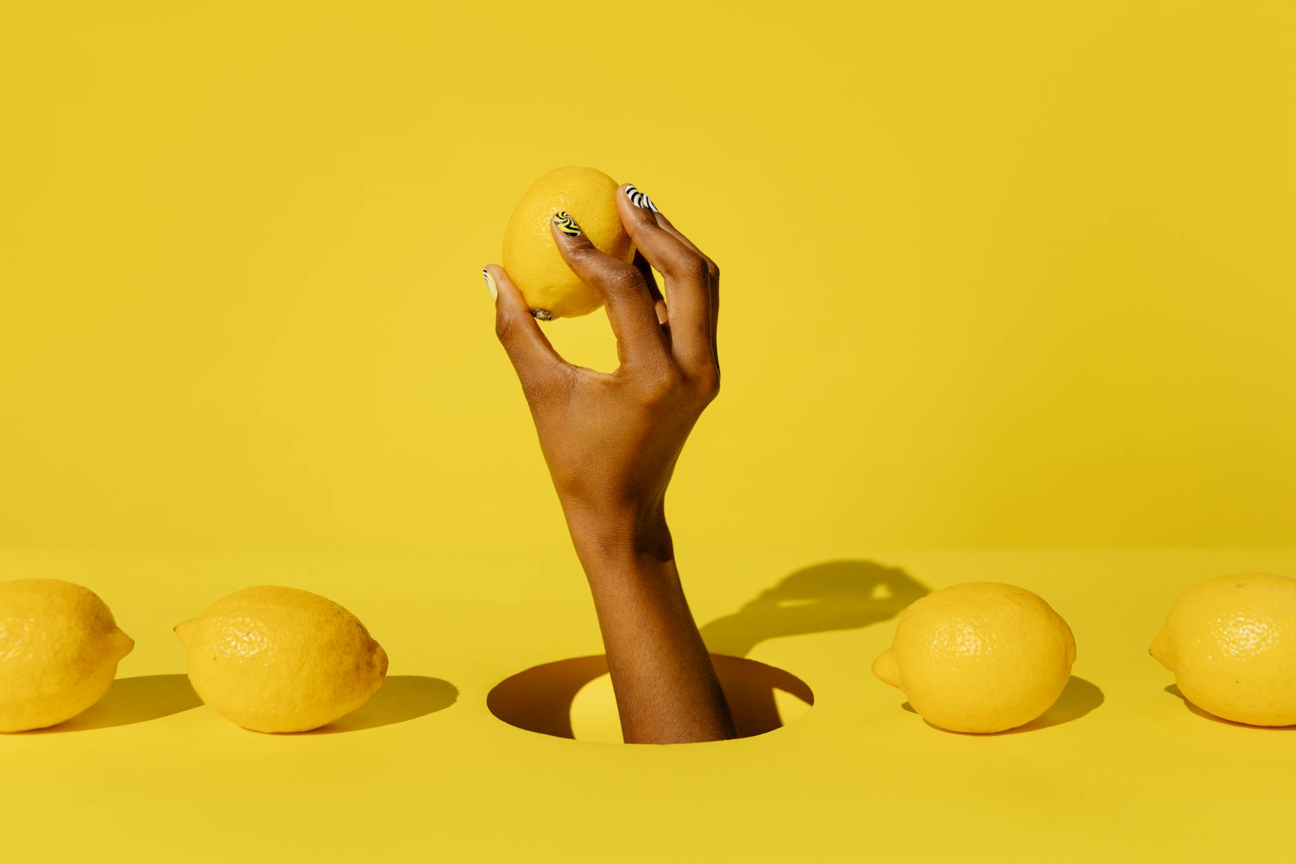 Hands holding colorful personal massagers against a purple background