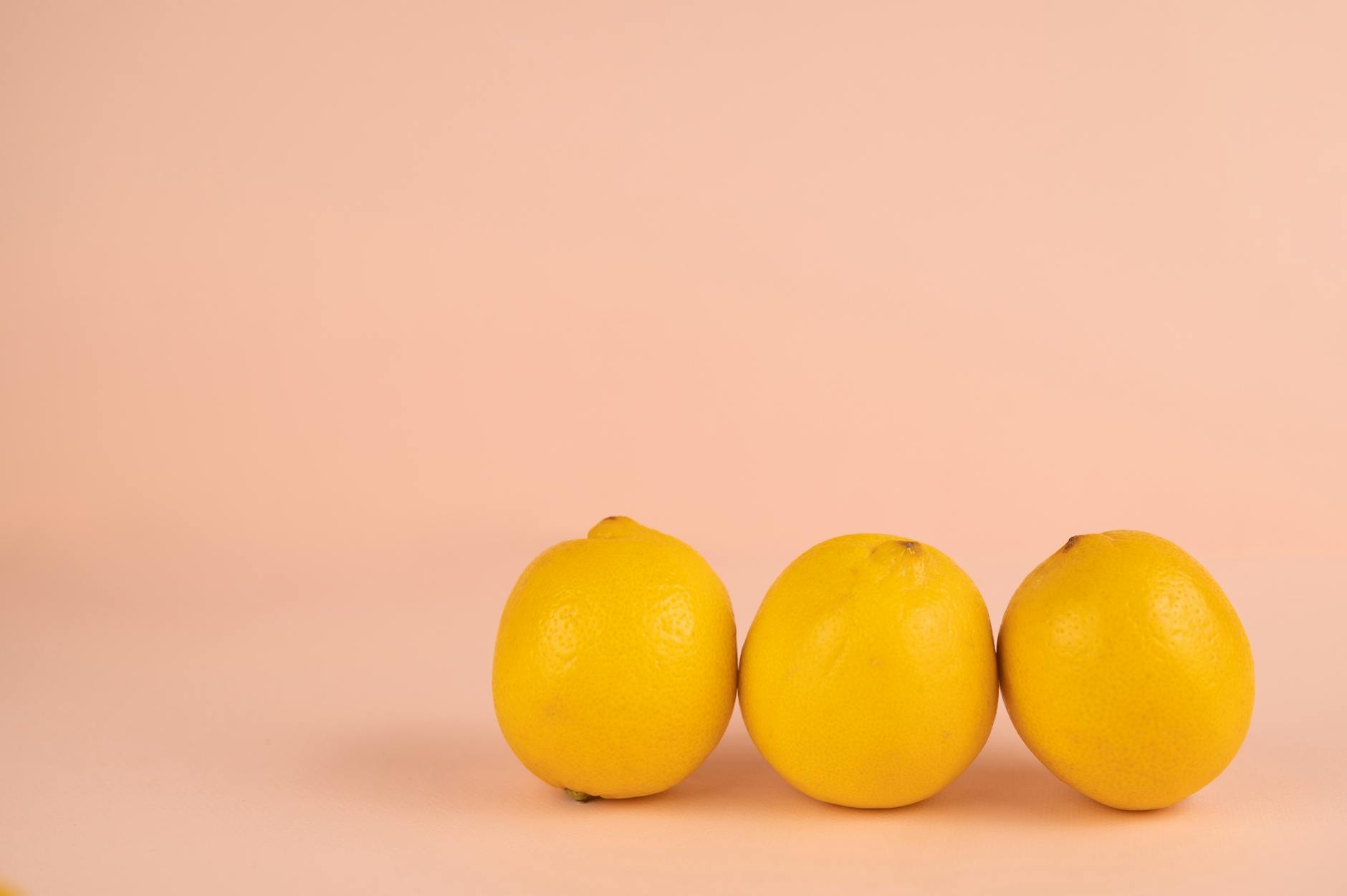 Bright ripe lemons on a pastel background, symbolizing fresh starts and renewal